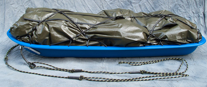 Pulk with load wrapped in a tarp