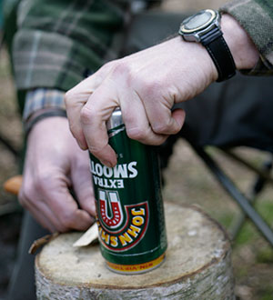 Use a  small piece of wood or stone to set the height of your knife blade and turn the tin to score a line.