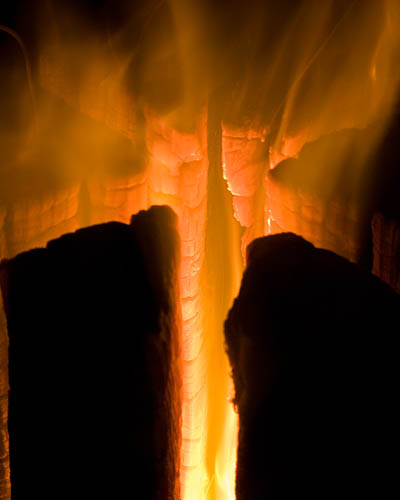 Fire Log ignited and burning well. - ©  Gary Waidson - Ravenlore Bushcraft and Wilderness skills.